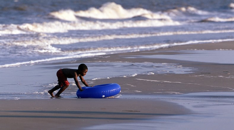 A boy plays in the surf in the Atlantic on Jekyll Island. (Louie Favorite/AJC 2001)
