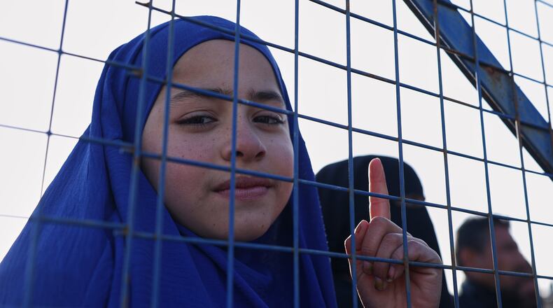 Sundus al-Hassan, 10, poses for a picture inside the al-Hol camp in northeastern Syria's Hasakeh province, Syria, Wednesday, Jan. 21, 2026, after the withdrawal of the Syrian Democratic Forces (SDF). (AP Photo/Ghaith Alsayed)
