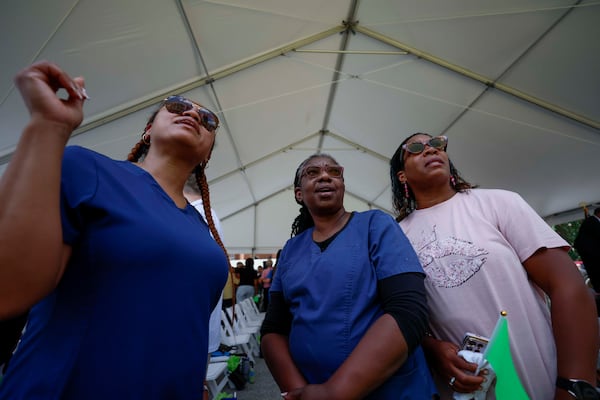 Left to right, registered nurses LaShundra Watson, Carol Lattany, and surgical technologist Ellen Bryant, observe with emotion the beginning of the demolition of Atlanta Medical Center as the site starts its transformation into a new phase of its development project on Monday, June 30, 2025. They all had multiple decades of service with the Atlanta Medical Center.
(Miguel Martinez/ AJC)