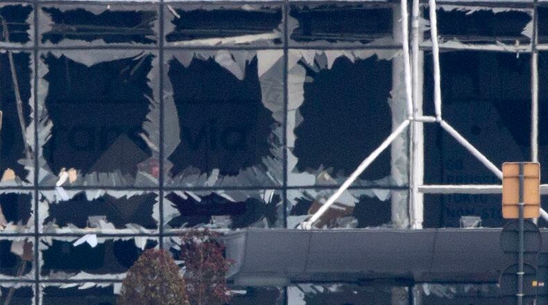 The blown out windows of Zaventem airport are seen after a deadly attack in Brussels, Belgium, Tuesday, March 22, 2016.