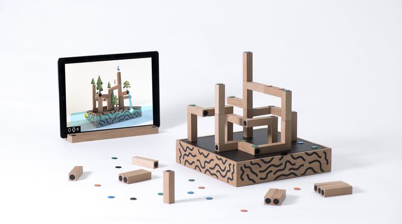 Koski’s game combines an iPad app and simple magnetic blocks to bring a maze adventure to life. (Nikola Zelmanovic/TNS)