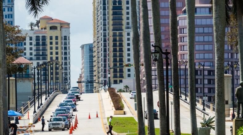 A queue of cars slowly passes through a police checkpoint on the Royal Park Bridge as residents and workers try to get back onto Palm Beach on Wednesday, September 13, 2017. Those who don’t live or work on the island are turned away.