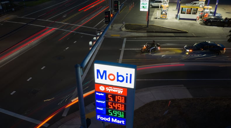 In this photo taken with a slow shutter speed, traffic moves past a sign for a Mobil gas station on Wednesday, April 29, 2026, in Portland, Ore. (AP Photo/Jenny Kane)