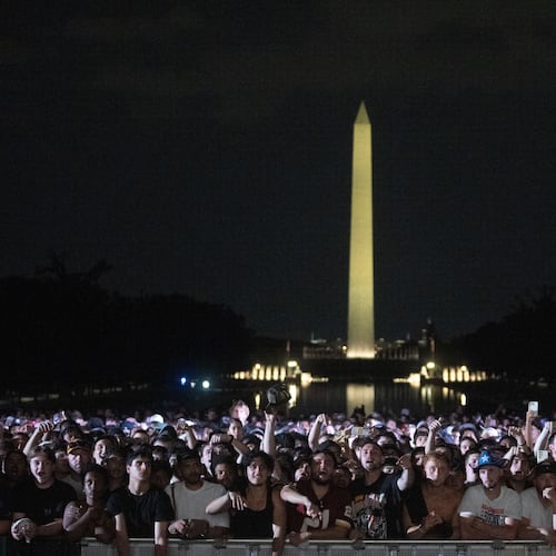 Audience members cheer and boo during a UFC news conference at the Lincoln Memorial, ahead of Sunday's fight on the South Lawn of the White House, Friday, June 12, 2026, in Washington. (AP Photo/Allison Robbert)