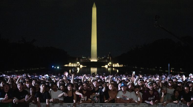 Audience members cheer and boo during a UFC news conference at the Lincoln Memorial, ahead of Sunday's fight on the South Lawn of the White House, Friday, June 12, 2026, in Washington. (AP Photo/Allison Robbert)