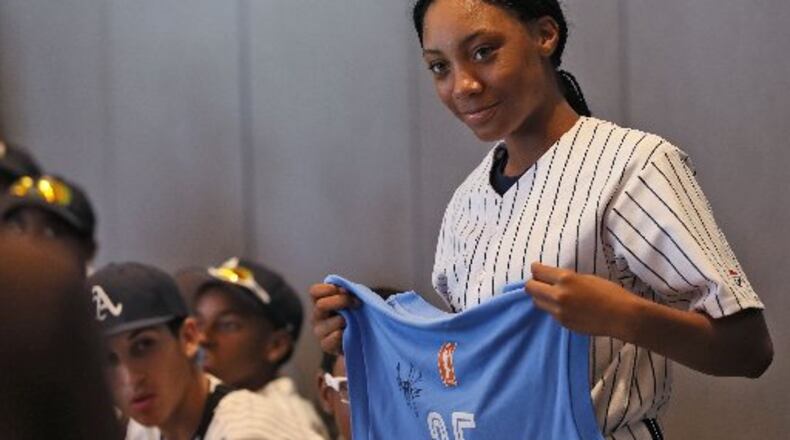 Mo’ne Davis, a pitcher with the Anderson Monarchs and one of the few black girls to play on a boy’s team, receives a jersey from Angela Taylor, president and general manager of the WNBA Atlanta Dream at the National Center for Civil and Human Rights. Davis pitches for the Anderson Monarchs, a little league team based in Philadelphia, which is making a 23-day civil rights tour. BOB ANDRES / BANDRES@AJC.COM