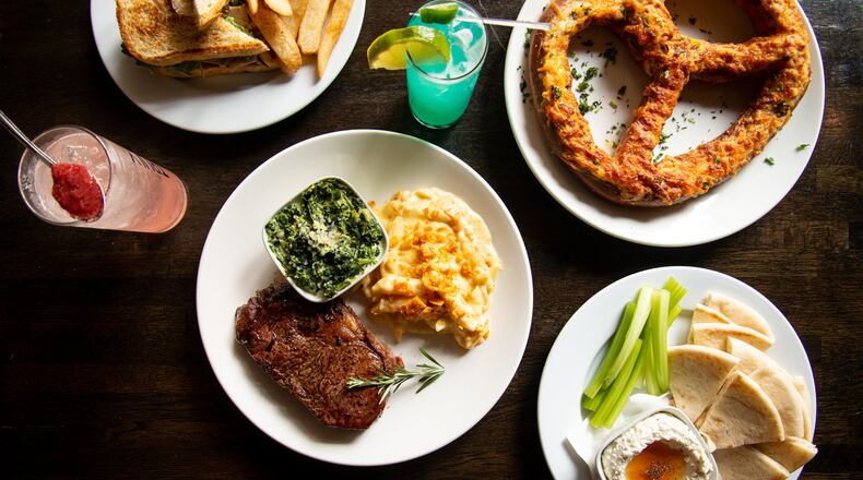 The Daily Tavern Cast Iron Ribeye, Pretzel, Whipped Feta, Warm Smoked Turkey Sandwich and Ghostface and AJC cocktails. Photo credit- Mia Yakel.