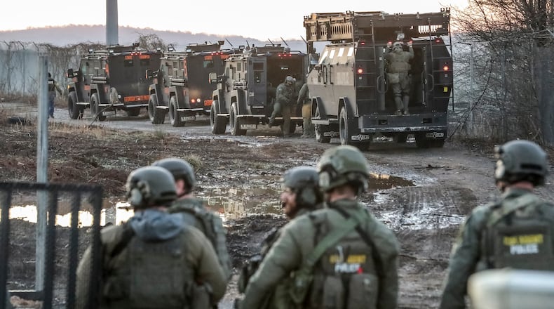 February 6, 2023 Atlanta Law enforcement was out en masse Monday morning, Feb. 6, 2023 at the site of Atlanta’s proposed public safety training center, clearing the woods in anticipation of construction on the controversial facility beginning in earnest. SWAT teams from the Atlanta, DeKalb County police departments, as well as Georgia State Patrol troopers and representatives from other agencies, were seen at the site in southwest DeKalb County. Construction contractors were also there with equipment. Amid the beeping of trucks backing up and the clanging of heavy equipment off Key Road, construction workers busily prepared the site with a backhoe and a bulldozer. Police officers in olive green uniforms patrolled the area atop all-terrain vehicles. The operation was taking place several days after officials announced that initial land disturbance permits had been approved for the $90-million facility — and about three weeks after a similar clearing operation resulted in the death of 26-year-old Manuel “Tortuguita” Teran. During that fatal Jan. 18 incident, Teran is accused of firing at troopers “without warning,” wounding one. Teran died after several other troopers returned fire, the Georgia Bureau of Investigation has said. (John Spink / John.Spink@ajc.com)