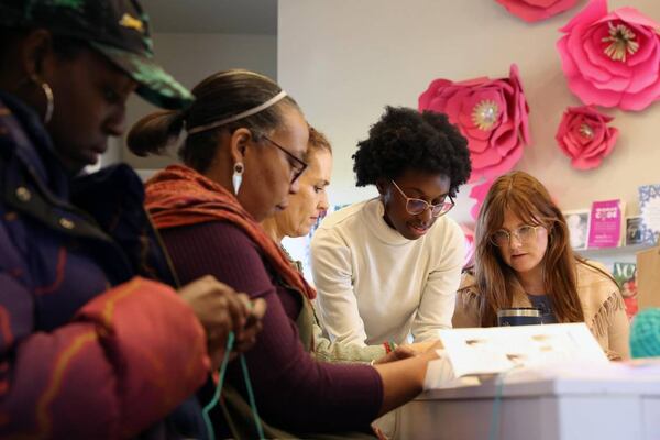 Judah David Creations owner Darice Oppong (second from right) helps team members from Resilient Middle Georgia practice their first stitches in her beginner crochet class on Wednesday, Dec. 11, 2024, at The Web in Macon, Georgia. (Photo Courtesy of Katie Tucker/The Telegraph)