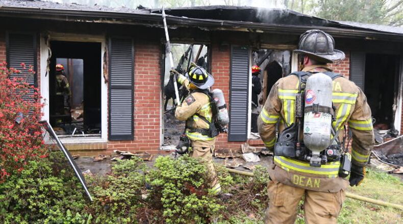 Atlanta firefighters were on the scene of a house fire on Collier Drive about 9 a.m. Tuesday, April 7, 2015. JOHN SPINK / JSPINK@AJC.COM