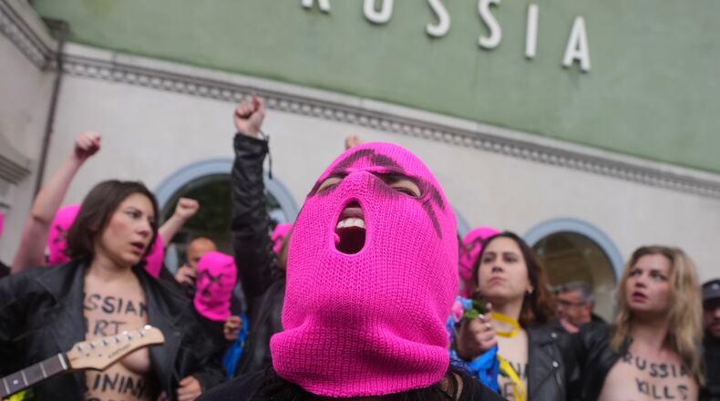 Pussy Riot and FEMEN activists stage a protest against Russia's presence after its absence following the 2022 invasion of Ukraine in front of the Russian pavilion, at the 2026 Art Venice Biennale, in Venice, Italy, Wednesday, May 6, 2026. (AP Photo/Luca Bruno)