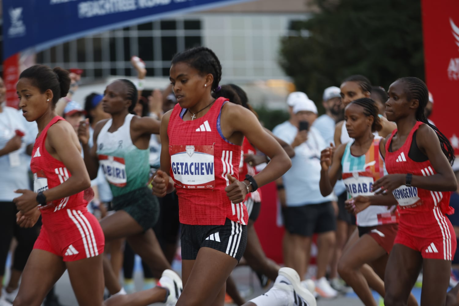 Elite women take off at the start of the 56th running of The Atlanta Journal-Constitution Peachtree Road Race in Atlanta on Friday, July 4, 2025.  (Arvin Temkar/AJC)