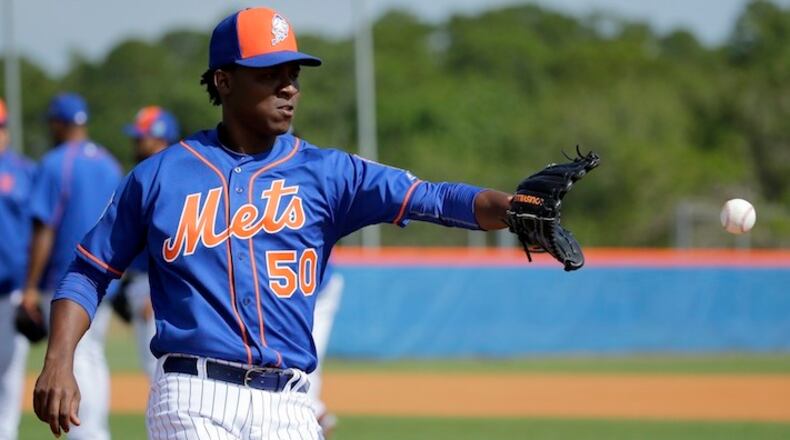 New York Mets pitcher Rafael Montero catches a ball during spring training baseball practice Friday, Feb. 19, 2016, in Port St. Lucie, Fla. (AP Photo/Jeff Roberson)