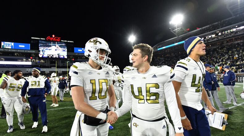 Georgia Tech quarterback Haynes King (10) and Georgia Tech long snapper Henry Freer (46) celebrate after Georgia Tech beat North Carolina State during an NCAA college football game at Bobby Dodd Stadium, Thursday, November 21, 2024, in Atlanta. Georgia Tech won 30-29 over North Carolina State. (Hyosub Shin / AJC)