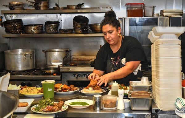 Khoury plates another order of chicken and waffle. AAJC082122SLAATLCULINARYJOURNEY (CHRIS HUNT FOR THE ATLANTA JOURNAL-CONSTITUTION)