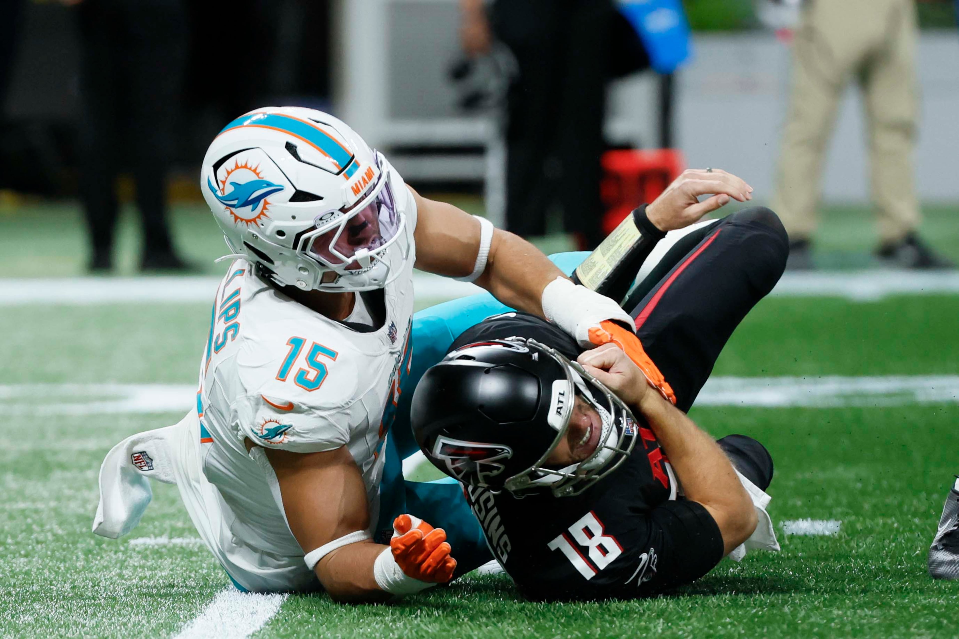 Atlanta Falcons quarterback Kirk Cousins hits the ground after being sacked by Miami Dolphins linebacker Jaelan Phillips during the first half of an NFL game at Mercedes-Benz Stadium in Atlanta on Sunday, Oct. 26, 2025. (Miguel Martinez/AJC)