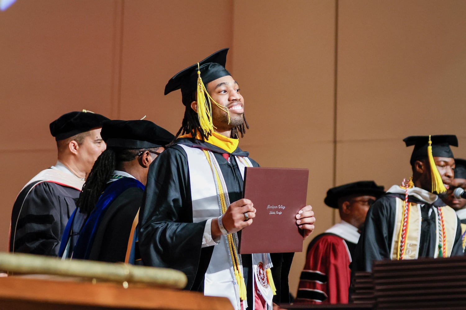 A Morehouse College graduate as he enters the stage with his degree during the 141st Commencement Ceremony of Morehouse College on Sunday, May 18, 2025.
(Miguel Martinez/ AJC)