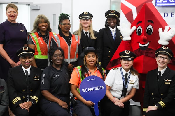 Pilots and ground crew members gather before Delta's annual WING Flight at Hartsfield-Jackson Atlanta International Airport on Friday, Sept. 19, 2025. This year, the flight took 120 young women to Kennedy Space Center for the day. (Abbey Cutrer/AJC)