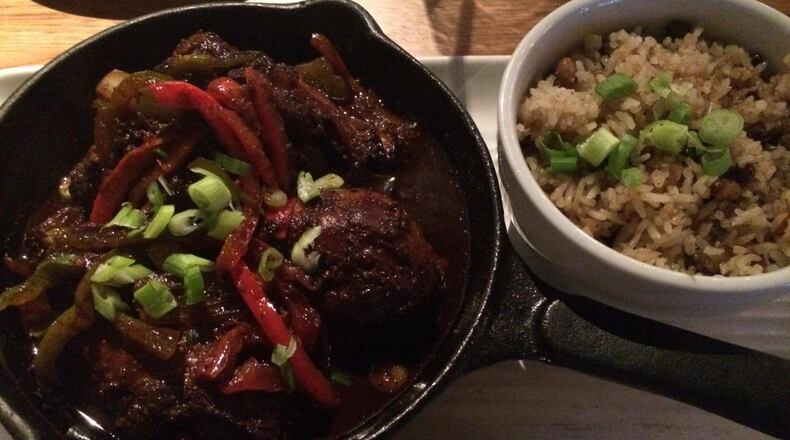 The brown-stew chicken with rice and peas is a standout at Ms. Icey’s Kitchen & Bar in Decatur. CONTRIBUTED BY WENDELL BROCK