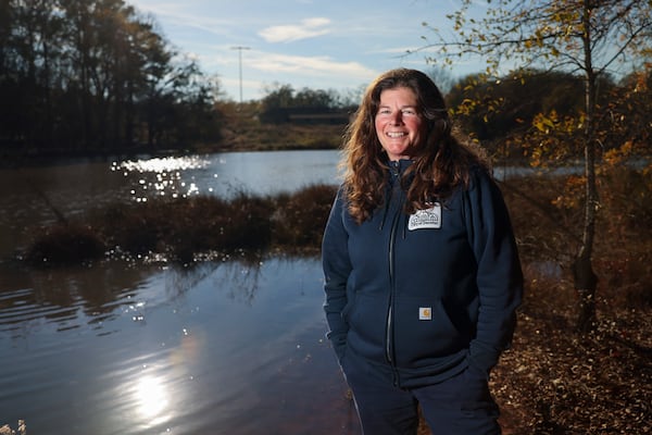 Allison Ericson, an urban naturalist with the city of Decatur, stands near Postal Pond at Legacy Park on Friday, Dec. 12, 2025. (Jason Getz / AJC)