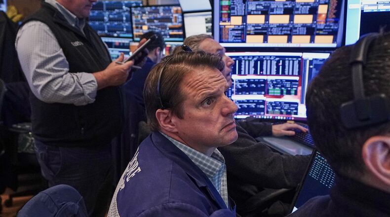 Trader Michael Milano, center, works on the floor of the New York Stock Exchange, Friday, June 26, 2026. (AP Photo/Richard Drew)