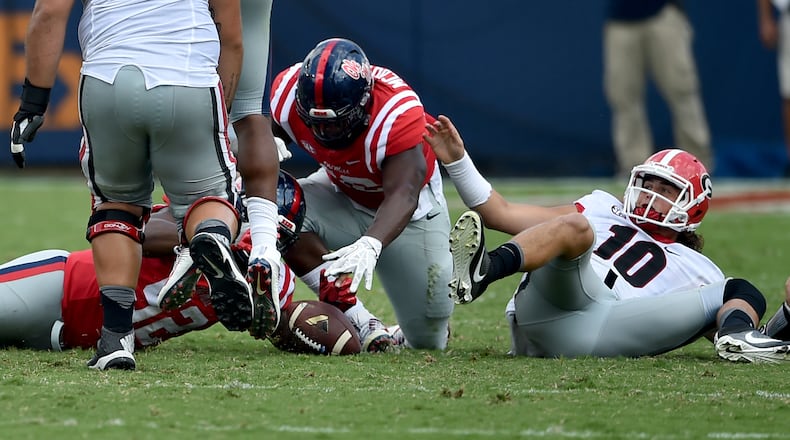 September 24, 2016 Oxford, Miss: Georgia Bulldogs quarterback Jacob Eason hits the ground as Ole Miss Rebels defensive tackle Austrian Robinson recovers his fumble in the second half in Oxford Saturday September 24, 2016. BRANT SANDERLIN/BSANDERLIN@AJC.COM