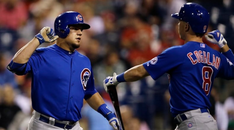 Chicago Cubs' Kyle Schwarber, left, and Chris Coghlan celebrate after Schwarber hit a home run off Philadelphia Phillies starting pitcher Jerad Eickhoff during the third inning of a baseball game, Saturday, Sept. 12, 2015, in Philadelphia. (AP Photo/Matt Slocum)