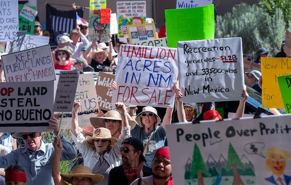 A few thousand people rally outside the Eldorado Hotel to protest against the sale of public lands by the Trump administration, during the Western Governors Association meeting in Santa Fe, N.M., Monday, June 23, 2025. (Eddie Moore/The Albuquerque Journal via AP)
