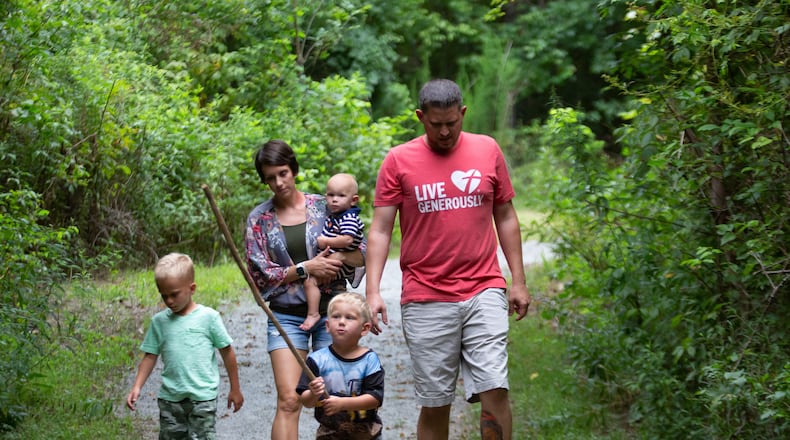 Angie Rush and her husband Aaron, along with their three sons, Carter, 1, Tristen, 6, and Caison, 3, take a walk near her Marietta home on July 27, 2020. STEVE SCHAEFER FOR THE ATLANTA JOURNAL-CONSTITUTION