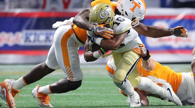 Georgia Tech quarterback TaQuon Marshall picks up short yardage as he is tackled by Tennessee linebacker Daniel Bituli during the first quarter in a NCAA college football game on Monday, September 4, 2017, in Atlanta. Curtis Compton/ccompton@ajc.com