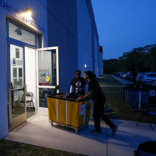 Poll workers deliver ballots at the Fulton County Election Center in Atlanta on Tuesday, May 19, 2026, during the 2026 Georgia primary elections. (Bob Andres for the AJC)