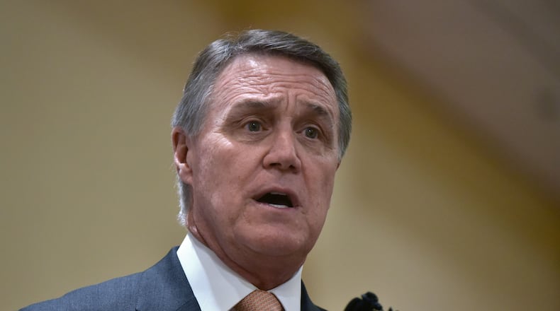 U.S. Sen. David Perdue speaks during the Brookhaven and DeKalb Chamber of Commerce luncheon on Tuesday. (AJC Photo / Hyosub Shin)