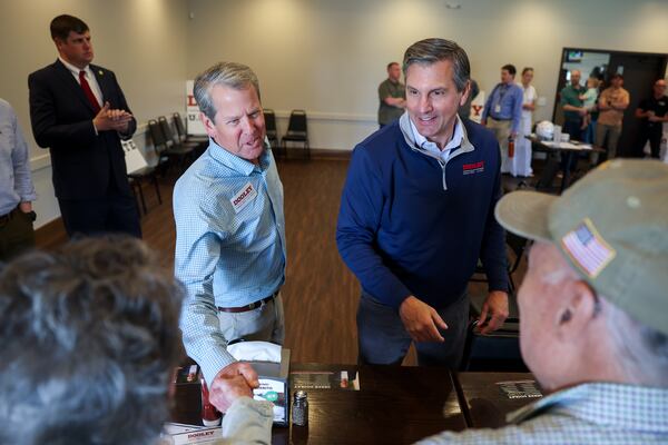 (L-R) Gov. Brian Kemp and Republican U.S. Senate candidate Derek Dooley greet supporters at campaign stop for Dooley at Farmview Market in Madison on May 8, 2026. (Arvin Temkar/AJC)