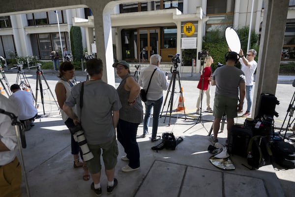 TV journalists work in front of the German Mission to the UN, ahead of a meeting for the Iran-EU nuclear meeting with the various foreign ministers of Germany, France, Great Britain and the EU to hold nuclear talks with their Iranian counterparts, in Geneva, Switzerland, Friday, June 20, 2025. (Martial Trezzini/Keystone via AP)