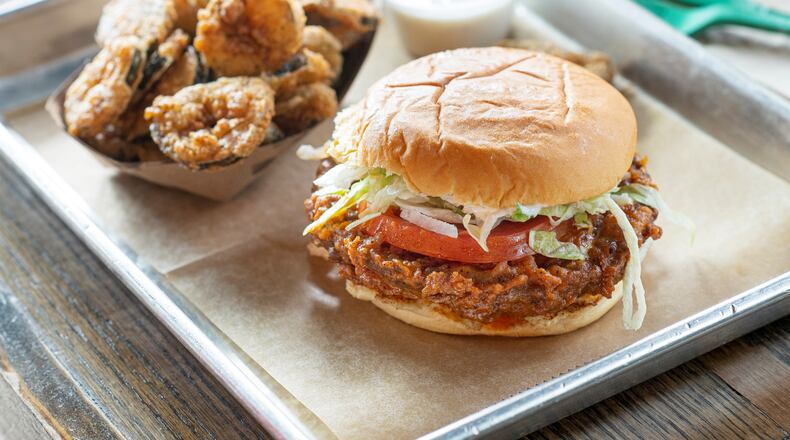 Fried pickles and The Buffalo sandwich which is Blue Cheese sauce, tomato, bibb lettuce and award-winning fried chicken.
(Courtesy of Boxcar Betty’s)