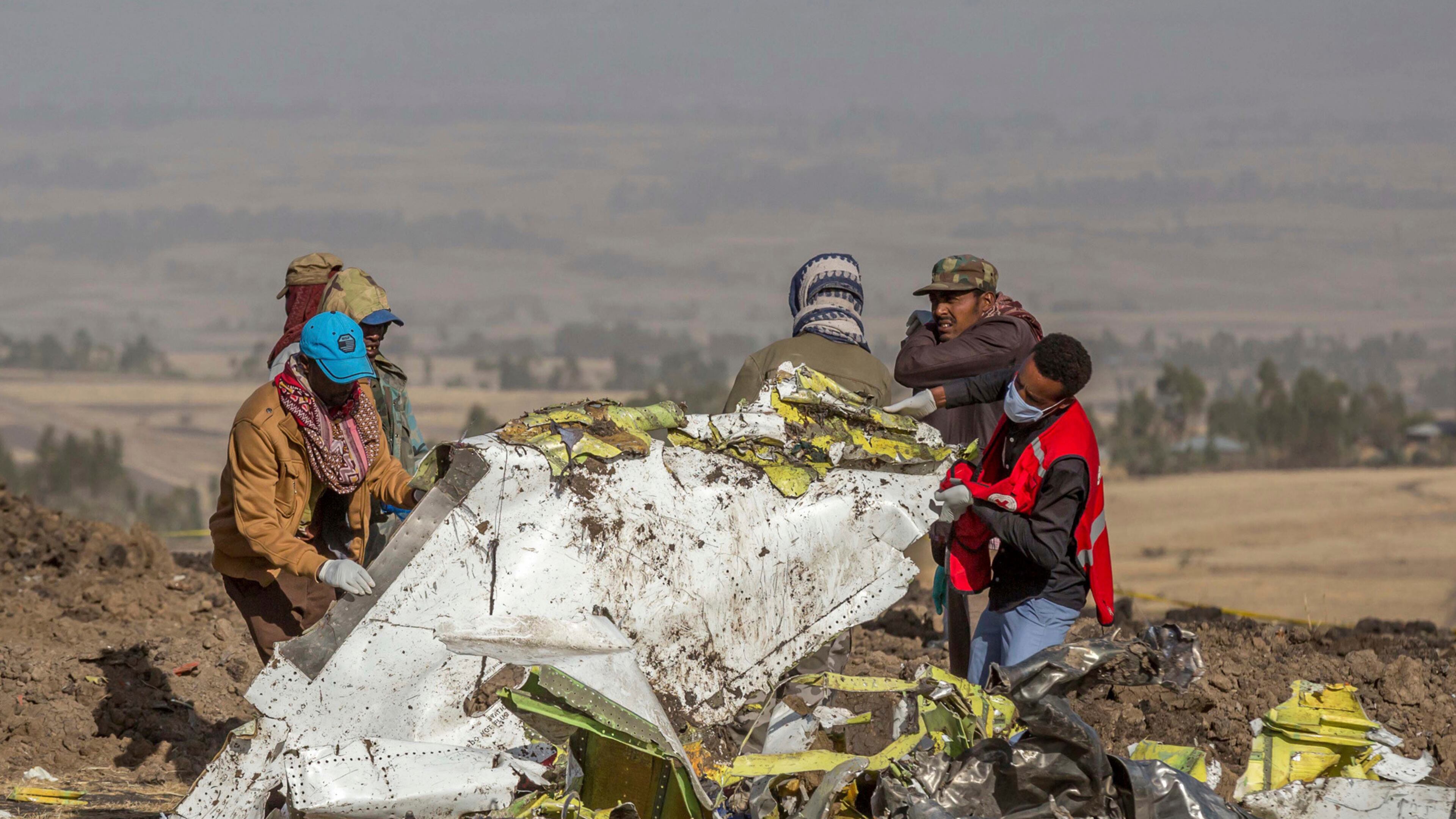 FILE - In this March 11, 2019, file photo, rescuers work at the scene of an Ethiopian Airlines flight crash near Bishoftu, Ethiopia. Pilot Bernd Kai von Hoesslin pleaded with his bosses for more training on the Boeing Max, just weeks before the Ethiopian Airline's jet crashed, killing everyone on board. (AP Photo/Mulugeta Ayene, File)