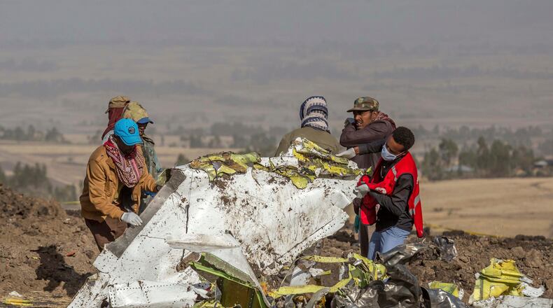 FILE - In this March 11, 2019, file photo, rescuers work at the scene of an Ethiopian Airlines flight crash near Bishoftu, Ethiopia. Pilot Bernd Kai von Hoesslin pleaded with his bosses for more training on the Boeing Max, just weeks before the Ethiopian Airline's jet crashed, killing everyone on board. (AP Photo/Mulugeta Ayene, File)