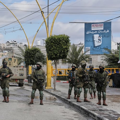 Israeli soldiers take up positions during an army raid in the West Bank city of Hebron Monday, Jan. 19, 2026. (AP Photo/Mahmoud Illean)