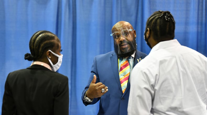 Timothy Hosea, regional manager with Hallmark Aviation Services, meets with job seekers at ATL Airport Career Fair at Georgia International Convention Center on Wednesday in June. The next job fair will be 11 a.m. to 6 p.m. on Wednesday Aug. 25 at the airport. (Hyosub Shin / Hyosub.Shin@ajc.com)