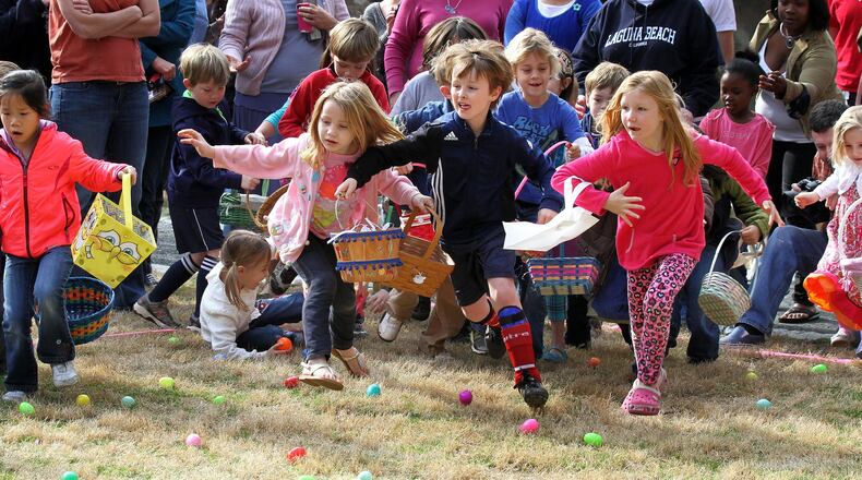 Kids age 10 and under scramble for colorful prizes during the city of Avondale Estates Annual Easter Egg Hunt at the Community Club on Lake Avondale in this file photo. This event will be held 10 a.m.-noon March 26 at Lake Avondale. AJC FILE PHOTO/2013