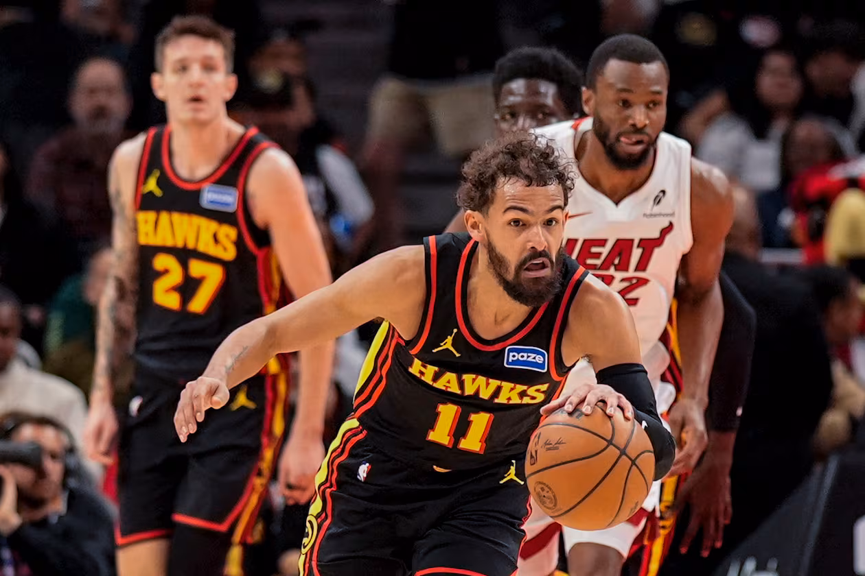 Atlanta Hawks guard Trae Young (11) drives against the Miami Heat during the first half of an NBA basketball game, Friday, Dec. 26, 2025, in Atlanta. (AP Photo/Mike Stewart)