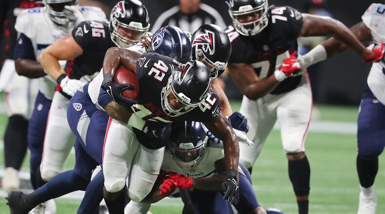 081321 Atlanta: Atlanta Falcons running back Caleb Huntley fights for some of the team's limited running yards against the Tennessee Titans during the second half of a NFL preseason football game on Friday, August 13, 2021, in Atlanta. “Curtis Compton / Curtis.Compton@ajc.com”