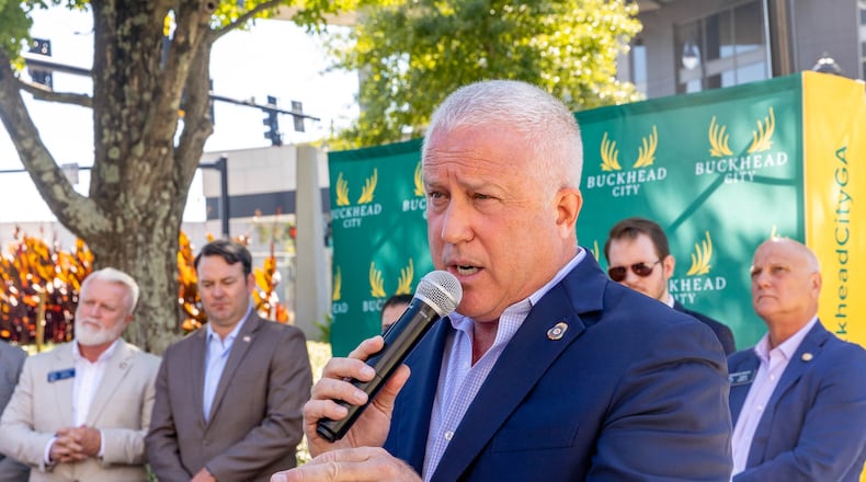 Buckhead City supporters, including Bill White, who is the Buckhead City Committee Chairman and CEO as well as area senators, local residents and some opposed to the creation of a new city gather for a press conference at Loudermilk Park on Wednesday, Sept 29, 2021.  The group announced that during the upcoming special legislative session the bill will be discussed.  Several state senators signed the bill onsite, illustrating support in the state Senate.  (Jenni Girtman for The Atlanta Journal-Constitution)