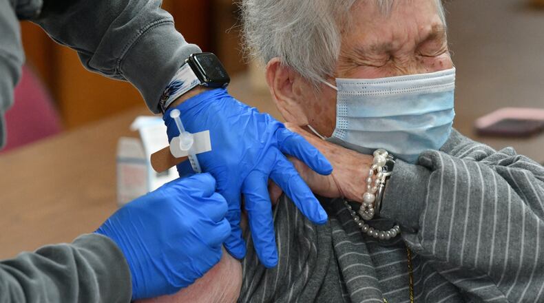 February 19, 2021 Decatur - A resident of AHEPA One Senior Apartments Hsiu Ying Lee receives a first dose of the Moderna vaccine from Pharmacist Demetrios Gavalas at AHEPA One Senior Apartments in Decatur on Friday, February 19, 2021. (Hyosub Shin / Hyosub.Shin@ajc.com)