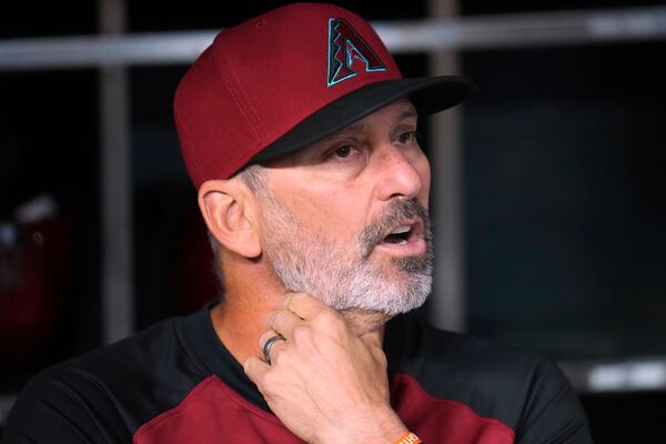 Arizona Diamondbacks manager Torey Lovullo pauses in the dugout prior to a baseball game against the Baltimore Orioles Wednesday, April 9, 2025, in Phoenix. (AP Photo/Ross D. Franklin)