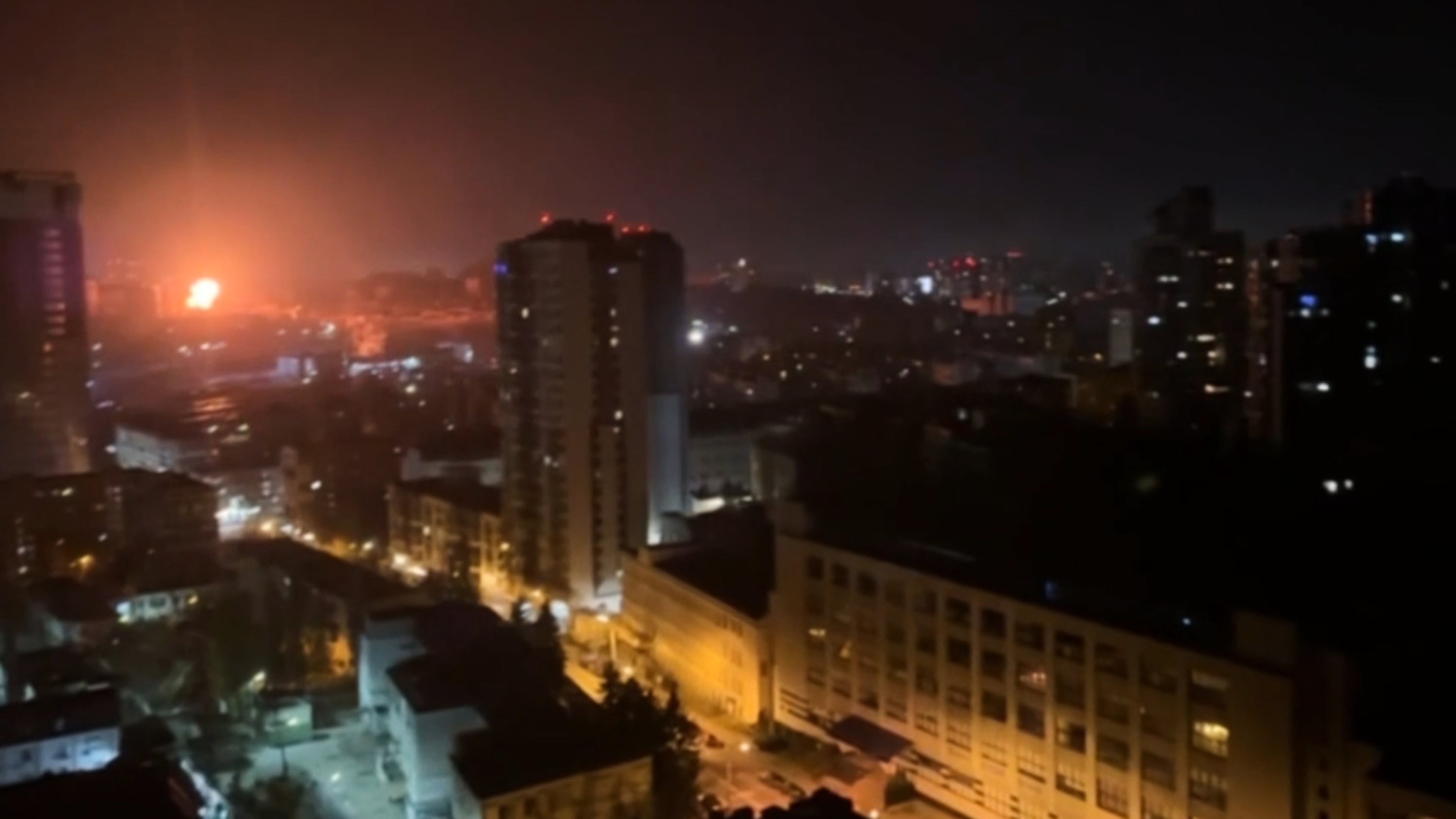 In this image taken from video, an explosion is seen in the distance as a Russian attack targets Ukraine's Kyiv region on Friday, Nov. 14, 2025.(AP Photo)