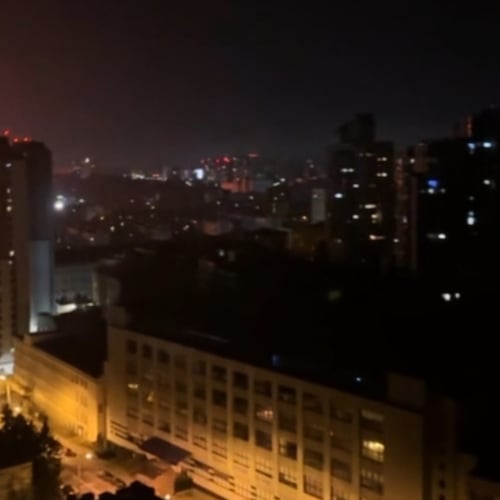 In this image taken from video, an explosion is seen in the distance as a Russian attack targets Ukraine's Kyiv region on Friday, Nov. 14, 2025.(AP Photo)