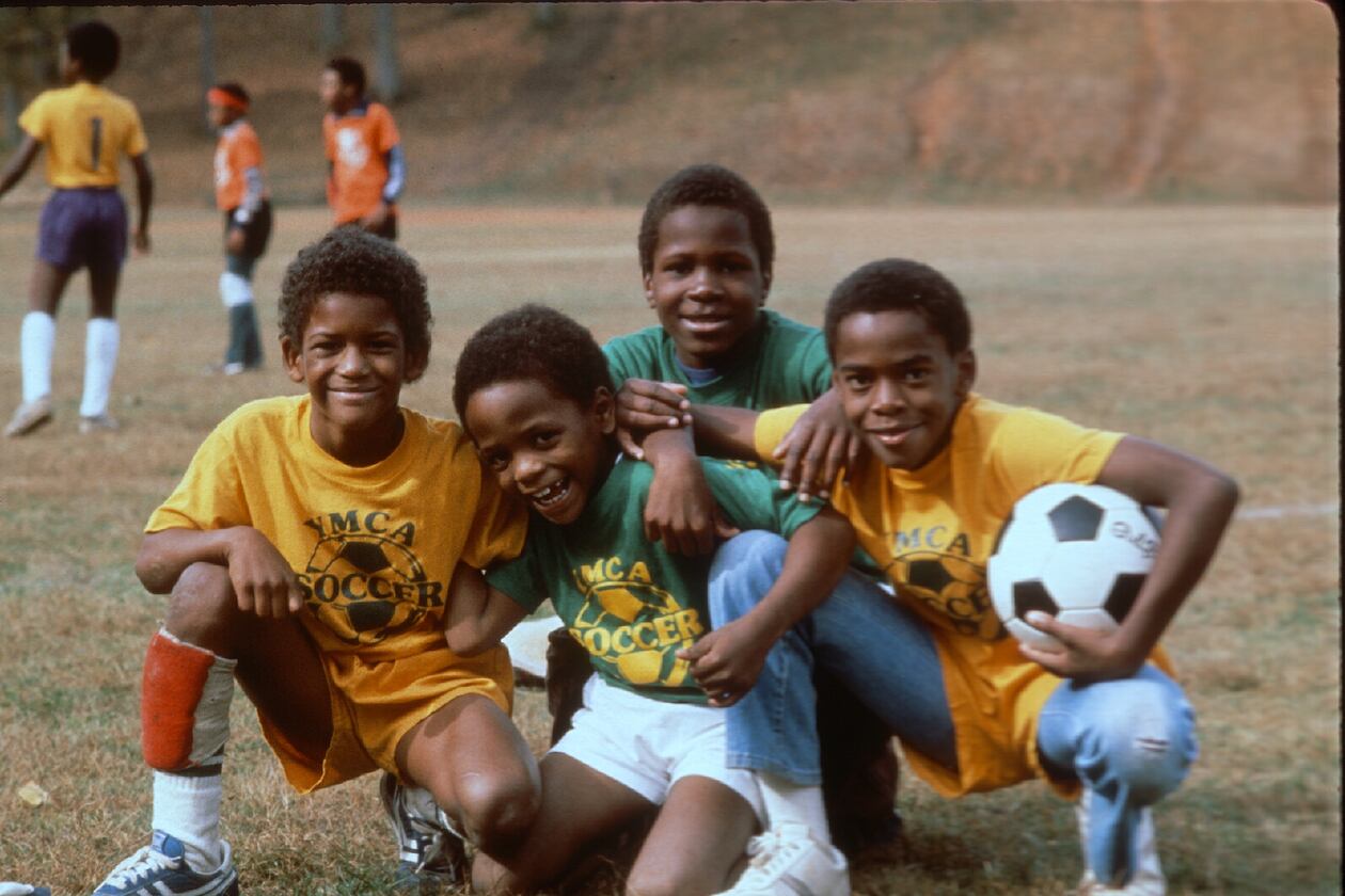 Four boys from a 1980s YMCA soccer team pose for a photo. (Courtesy of YMCA of Metro Atlanta)