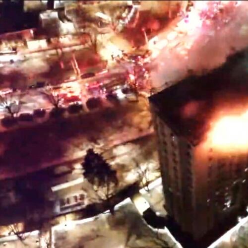 This image provided by FDNY shows FDNY members operating at a fire on the top two floors of a high-rise apartment in the Bronx, New York City, early Saturday, Jan. 24, 2026. (FDNY via AP)