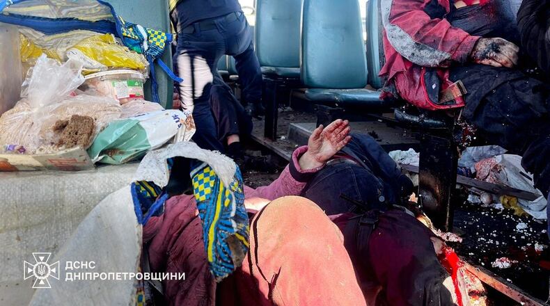 In this photo provided by the Ukrainian Emergency Services on Tuesday, April 7, 2026, rescue workers evacuate injured people from a bus attacked by a Russian drone in Nikopol, Dnipropetrovsk region, Ukraine. (Ukrainian Emergency Service via AP)
